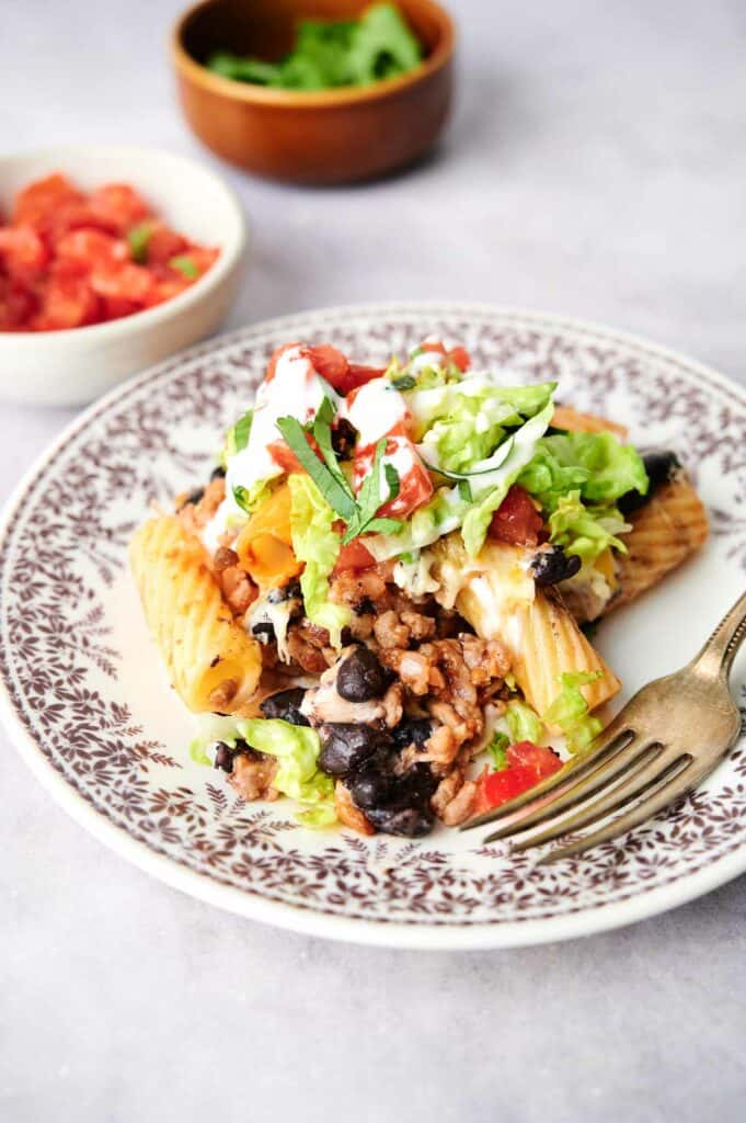 Walking taco casserole with black beans and tomatoes on a plate.