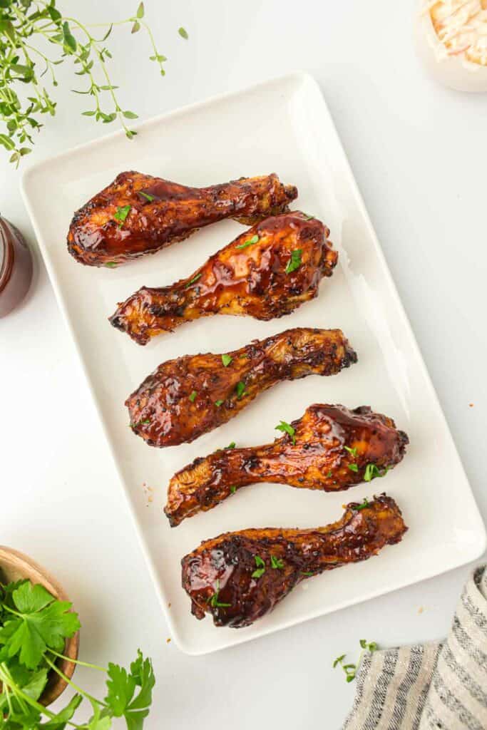 Air fryer BBQ chicken wings on a white plate.