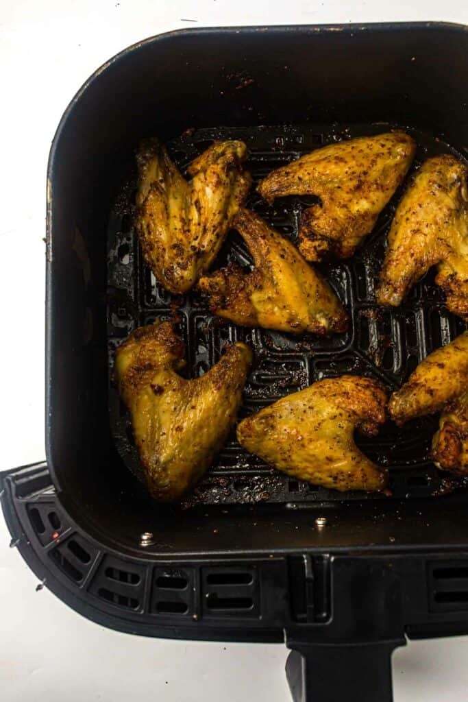 Cooked delicious crispy chicken wings in an air fryer.