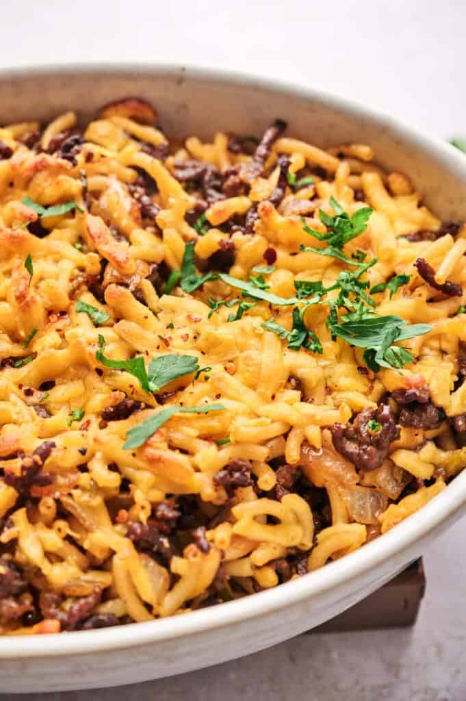 A white dish with a cheeseburger casserole.