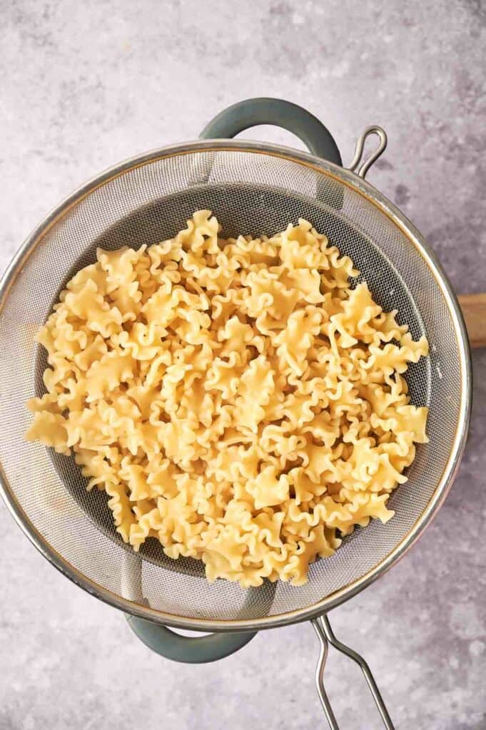 Pasta in a metal pan.