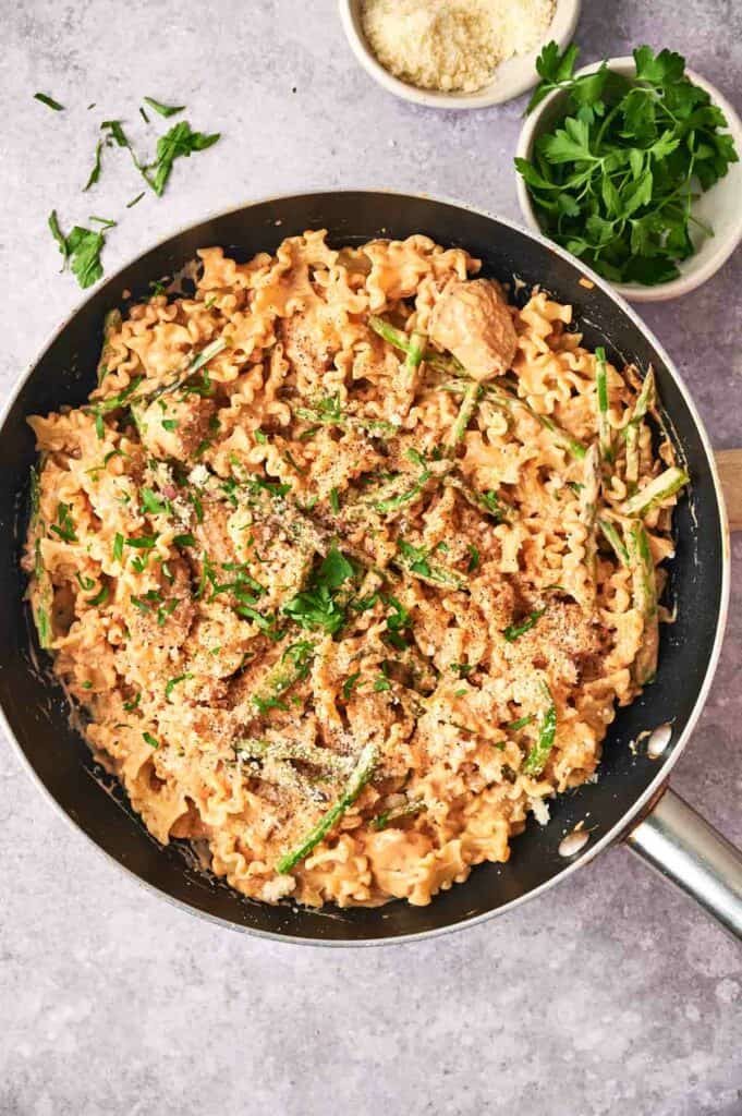 Chipotle pasta with meat and asparagus.
