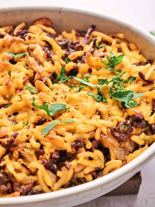 A bowl of food with cheese and meat.