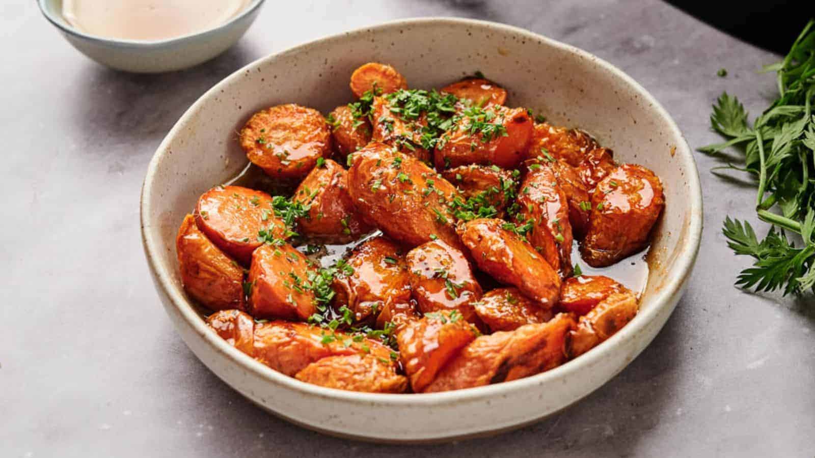 Air fryer glazed carrots in a bowl with parsley.