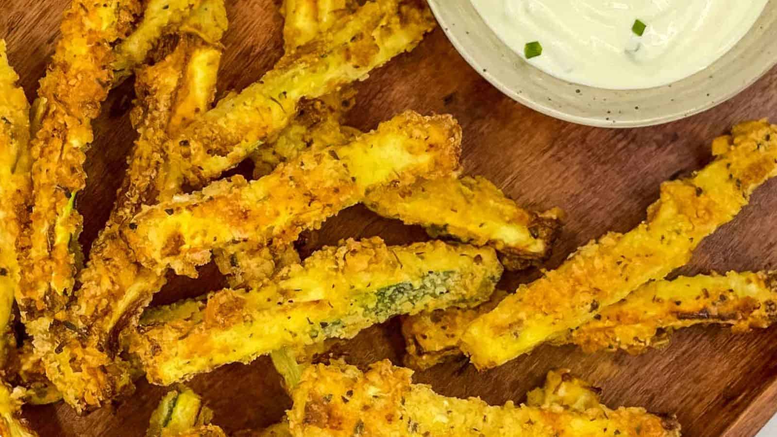 Air fryer zucchini fries on a wooden board.