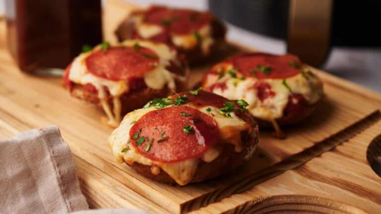 Bagel bites in an air fryer basket.