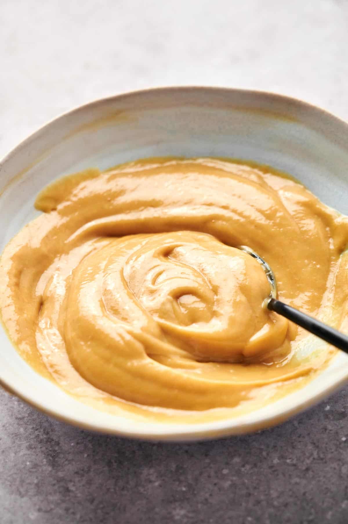 Chick-fil-A sauce in a sauce cup with a spoon.