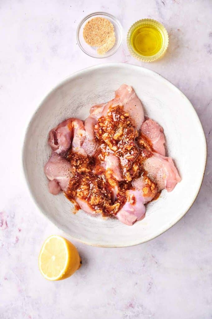 chicken marinated in a bowl.