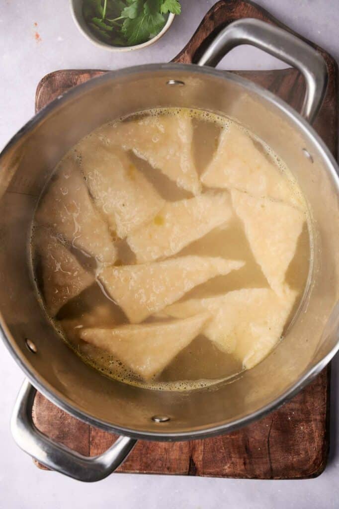 Dumplings floating in a pot for a cracker barrel chicken soup.