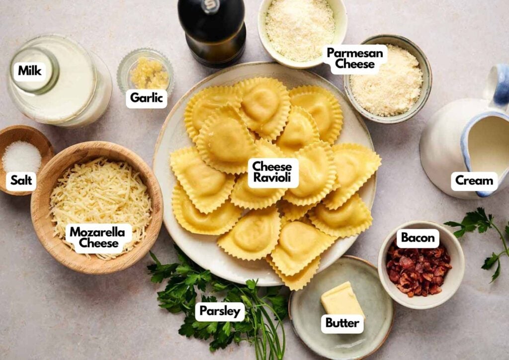 Ingredients for an Olive Garden Ravioli Carbonara are arranged on a table, featuring cheese ravioli, mozzarella, parmesan, milk, cream, butter, bacon, garlic, salt, and parsley.