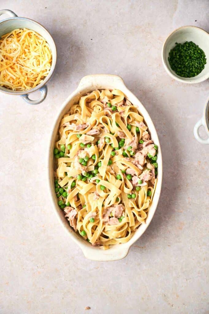 tuna casserole ingredients mixed in a baking dish.