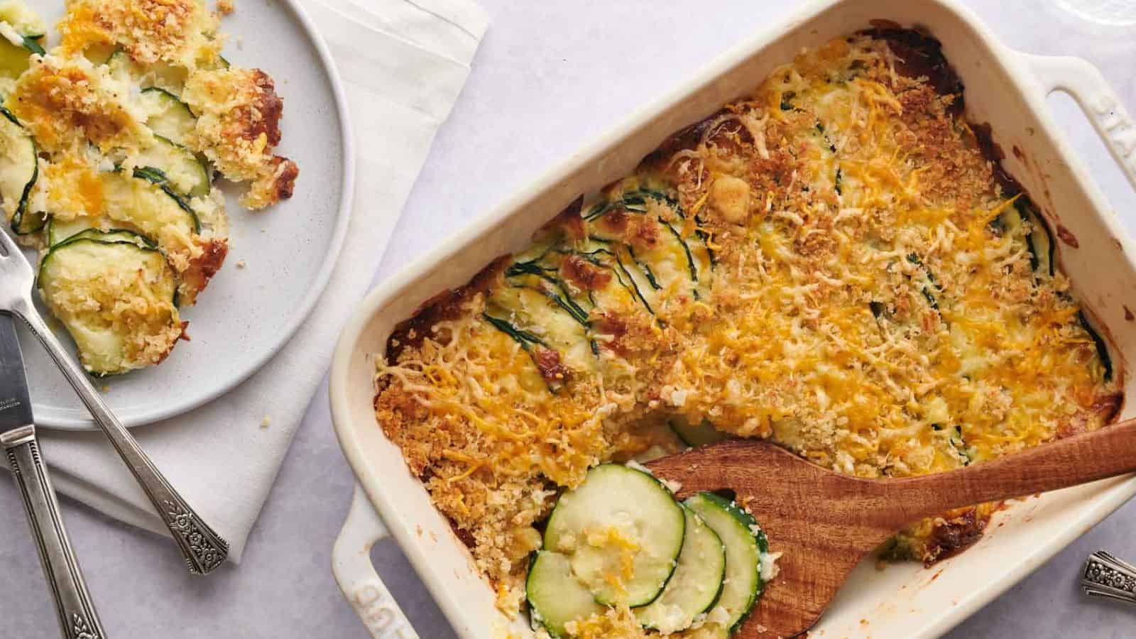 A casserole dish with zucchini and cheese on it.