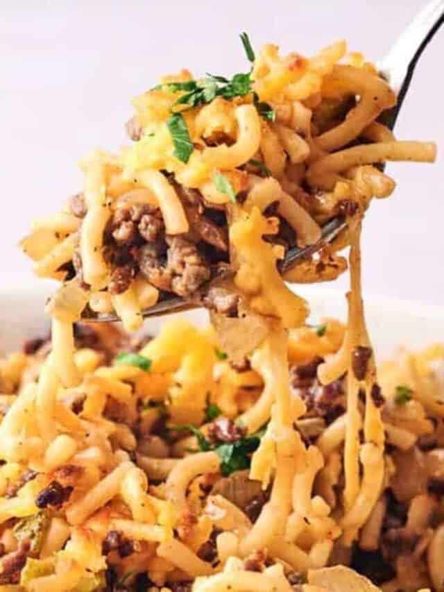 A fork lifting a portion of cheesy ground beef pasta with melted cheese stretching from the dish.