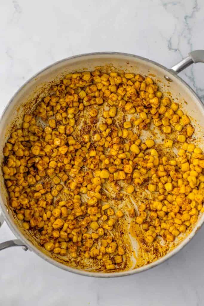 A pot with seasoned corn kernels.