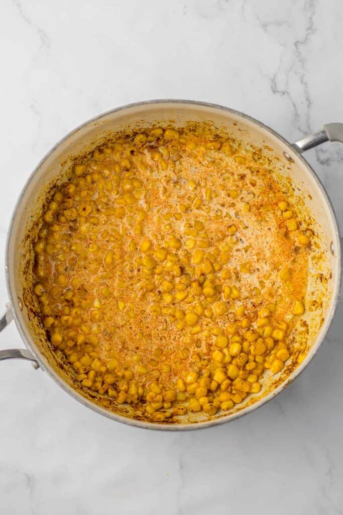 A pot of corn kernels with heavy cream.