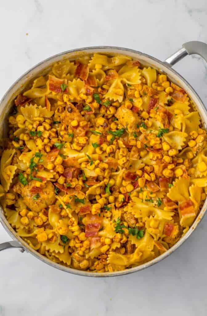 A pot with cooked chicken and corn pasta