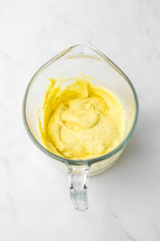 a bowl with a mixture of ingredients for a creamy ranch chicken recipe