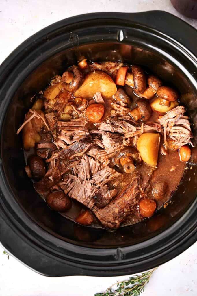 Slow cooker pot roast with carrots and potatoes.