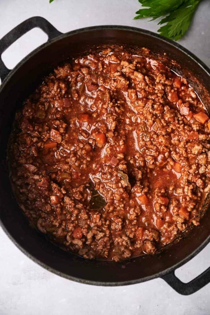 Ground beef in a skillet for a spaghetti Bolognese recipe.