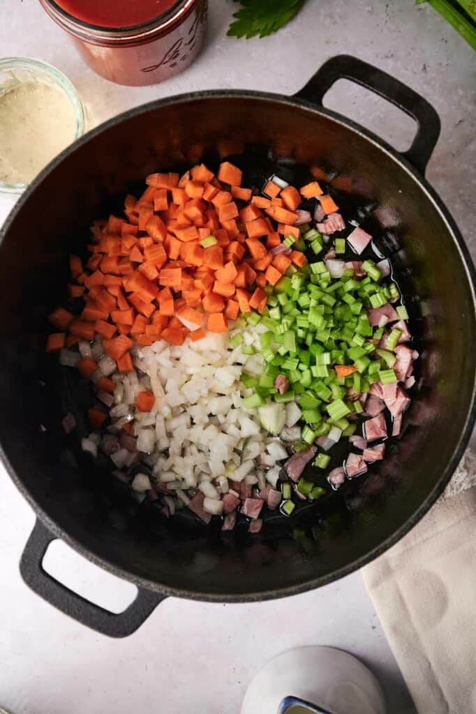 Chopped vegetables being cooked in a skillet.