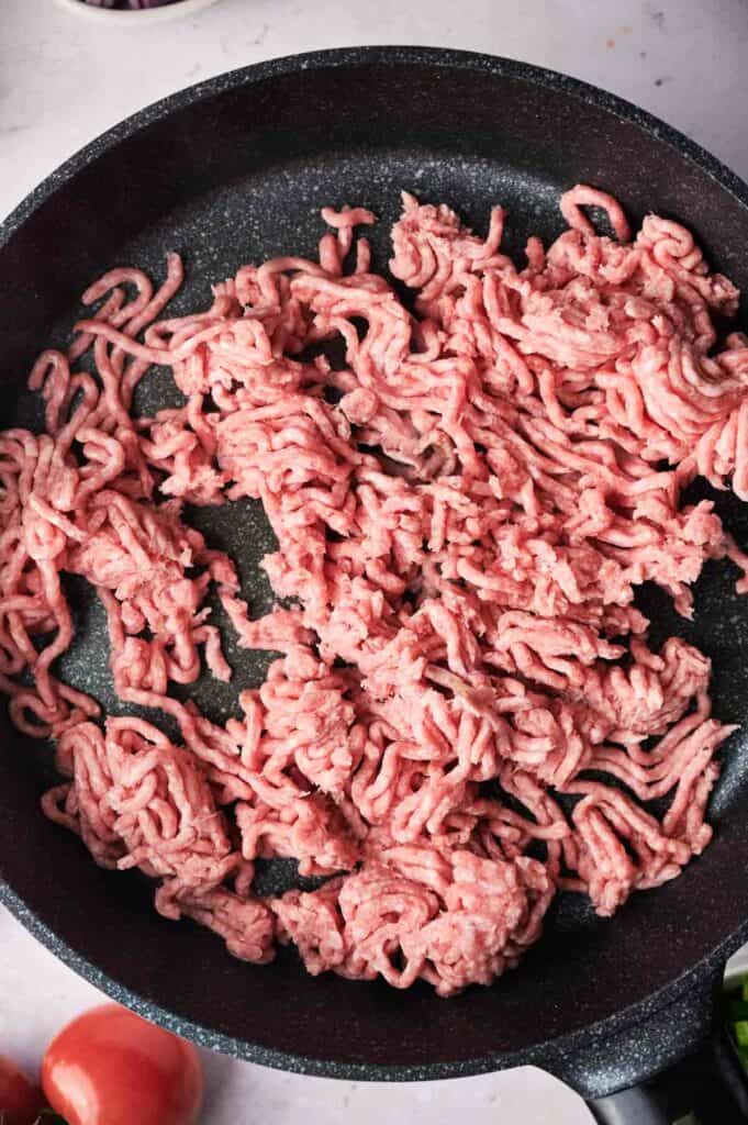 ground beef being cooked in a skillet.