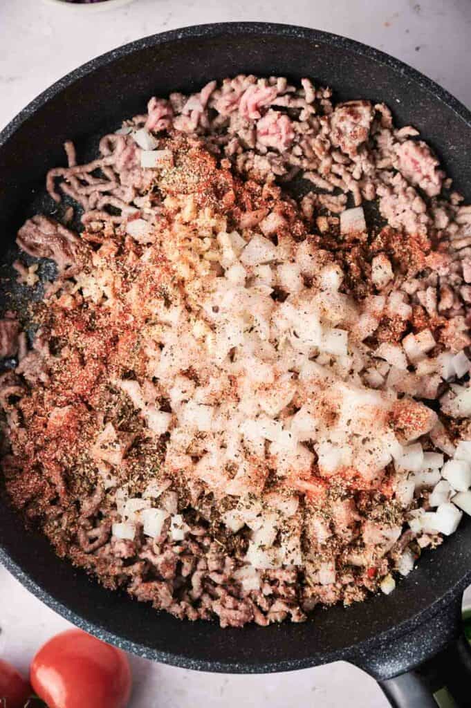 ground beef being cooked in a skillet.
