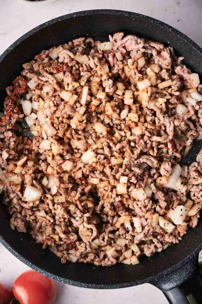 ground beef being cooked in a skillet.