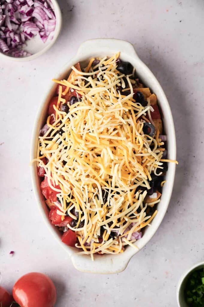 Taco Casserole with cheese on top in a baking dish.