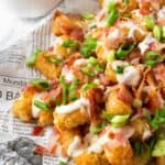Loaded Tater Tots on a plate.