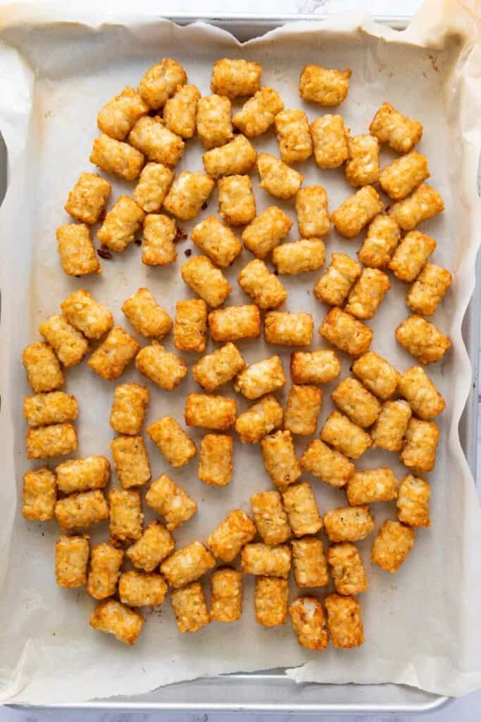 cooked tater tots on a baking sheet