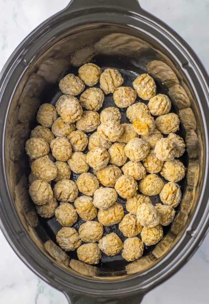 raw meatballs in a slow cooker