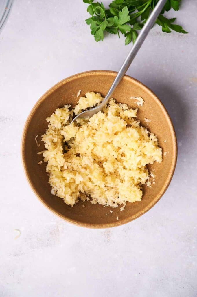 A bowl with a mixture of cheese and breadcrumbs