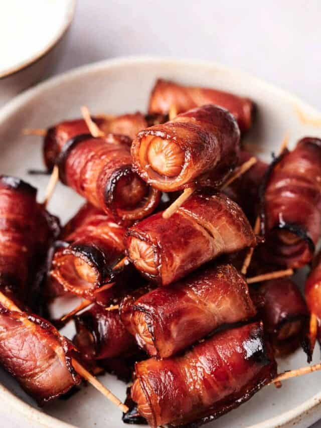 A plate of bacon-wrapped sausages secured with toothpicks.