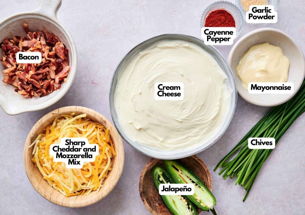Bowls filled with cream cheese, bacon, sharp cheddar and mozzarella mix, jalapeño, mayonnaise, garlic powder, cayenne pepper, and fresh chives—everything you need to whip up irresistible Bacon Jalapeno Popper Cheese Balls.