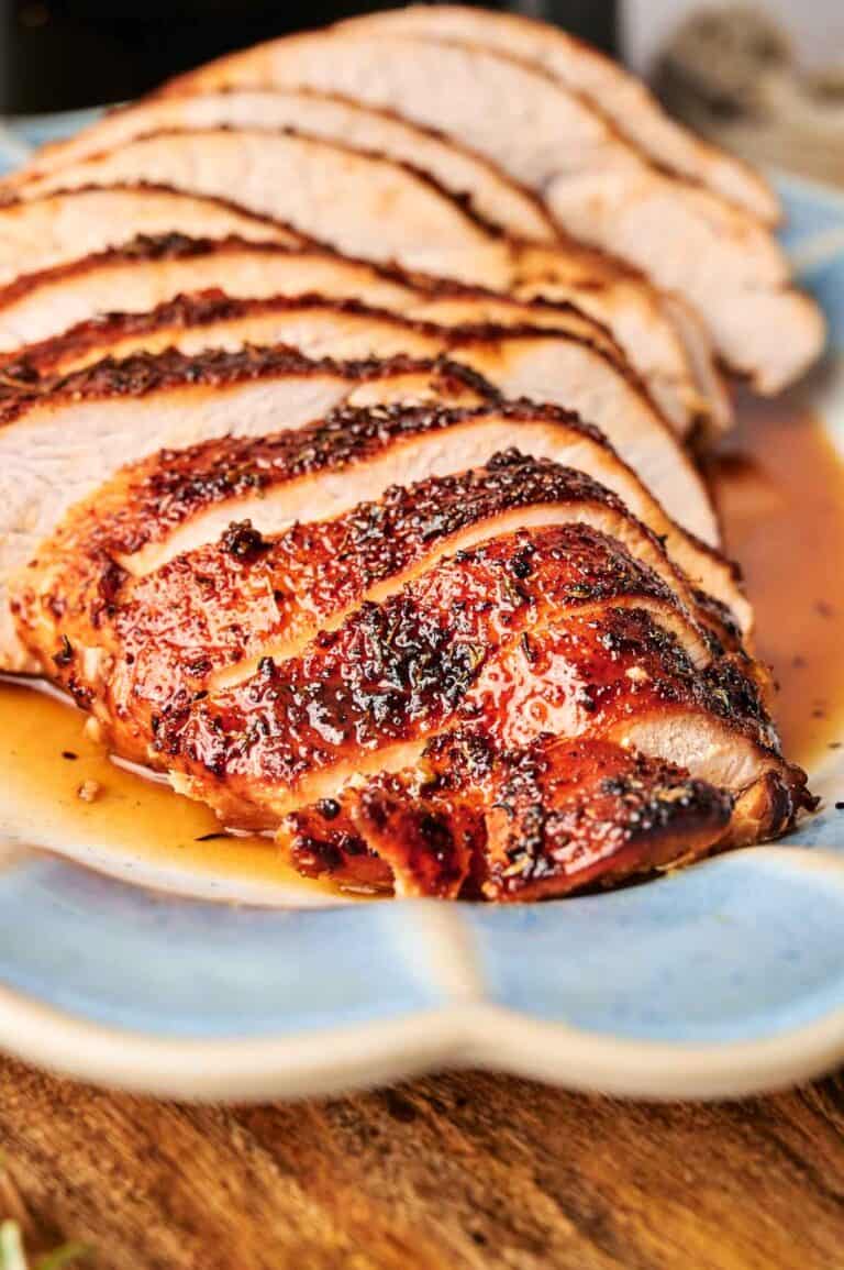 Slices of seasoned and cooked meat arranged on a blue plate.