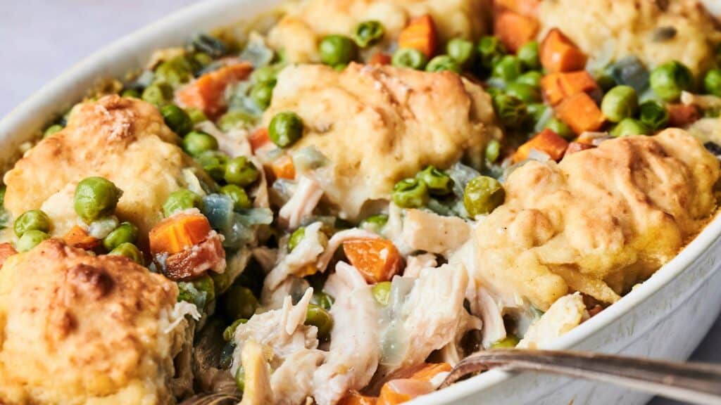 Experience the delightful Air Fryer Chicken and Dumpling Casserole, featuring baked dumplings alongside tender pieces of chicken, fresh peas, carrots, and a creamy sauce. This comforting dish combines classic flavors with modern convenience for a satisfying meal.