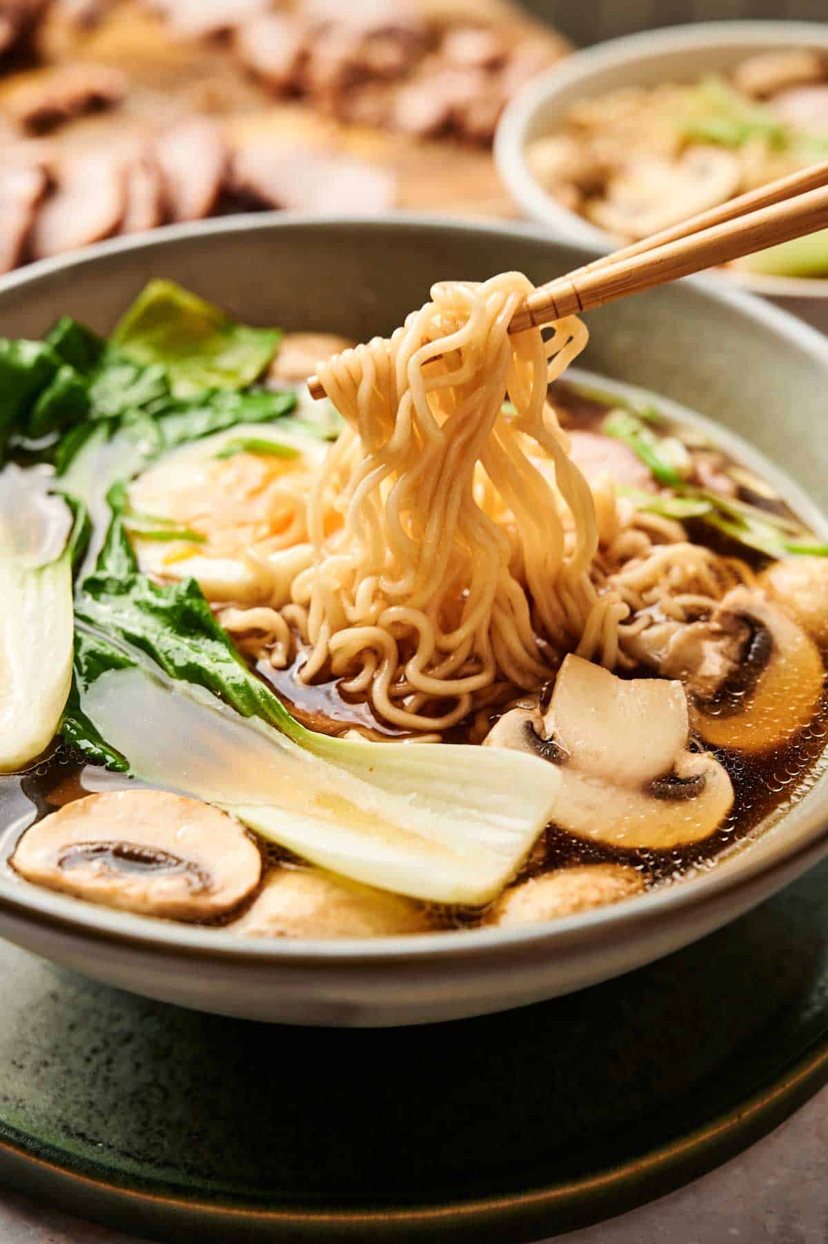Shortcut Tonkotsu Ramen in a bowl with pork, mushrooms, bok choy, noodles, and egg
