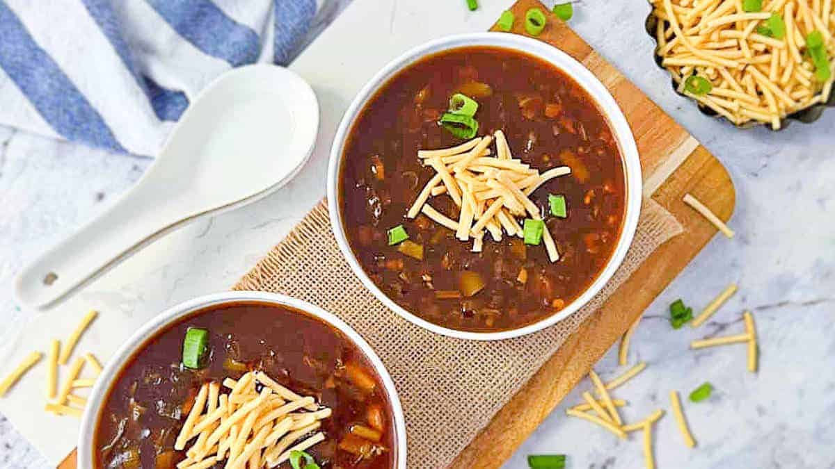 Veg manchow soup in white bowls.