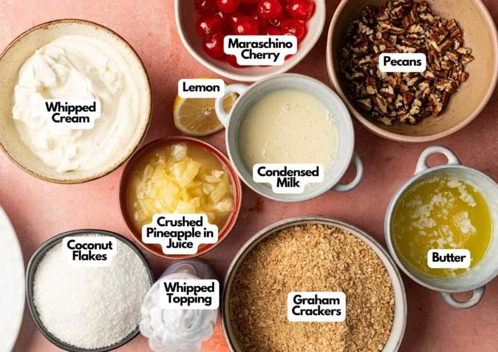 Various dessert ingredients in bowls, including whipped cream, coconut flakes, crushed pineapple, condensed milk, pecans, butter, and graham crackers&mdash;everything you need to make a classic Million Dollar Pie.