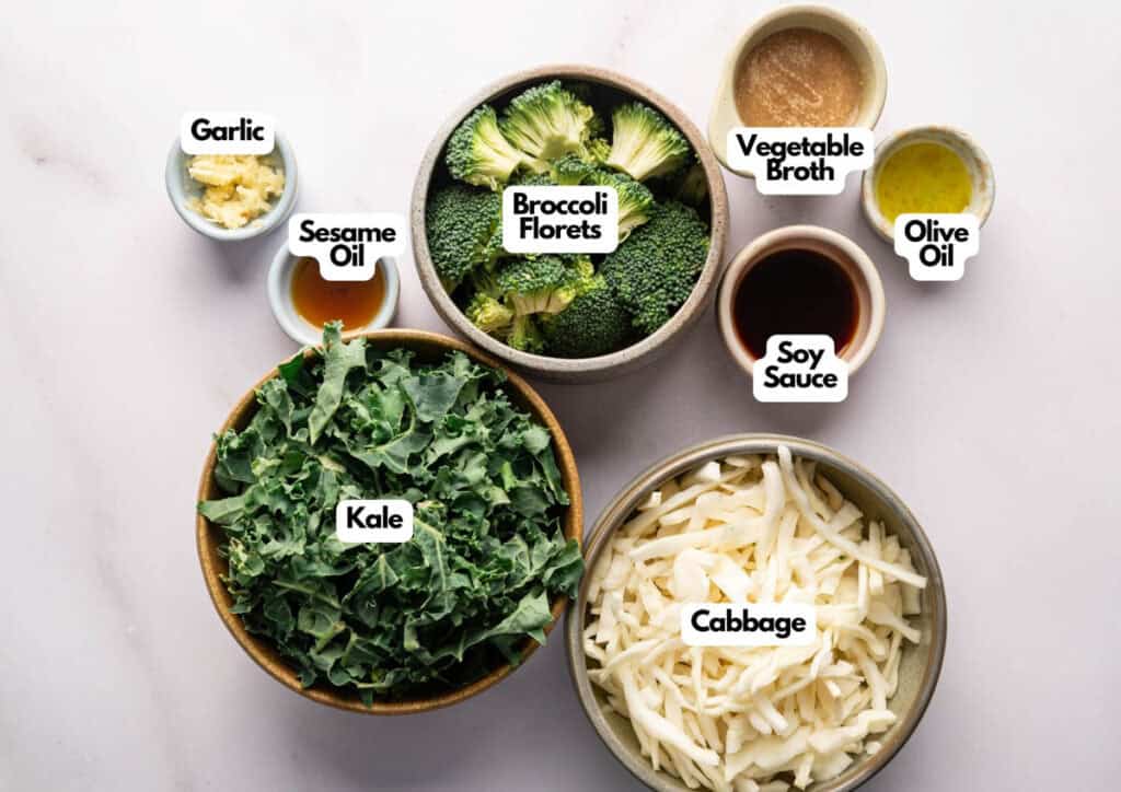 Bowls containing chopped garlic, sesame oil, broccoli florets, vegetable broth, olive oil, soy sauce, shredded kale, and shredded cabbage on a light surface—just like the wholesome mix in Panda Express Super Greens.