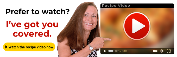 Smiling woman points at a large play button on a video player screen with text promoting a recipe video.