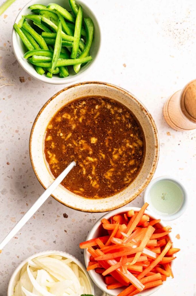 Savory soy sauce mixture whisked smooth, ready for stir frying beef and vegetables.